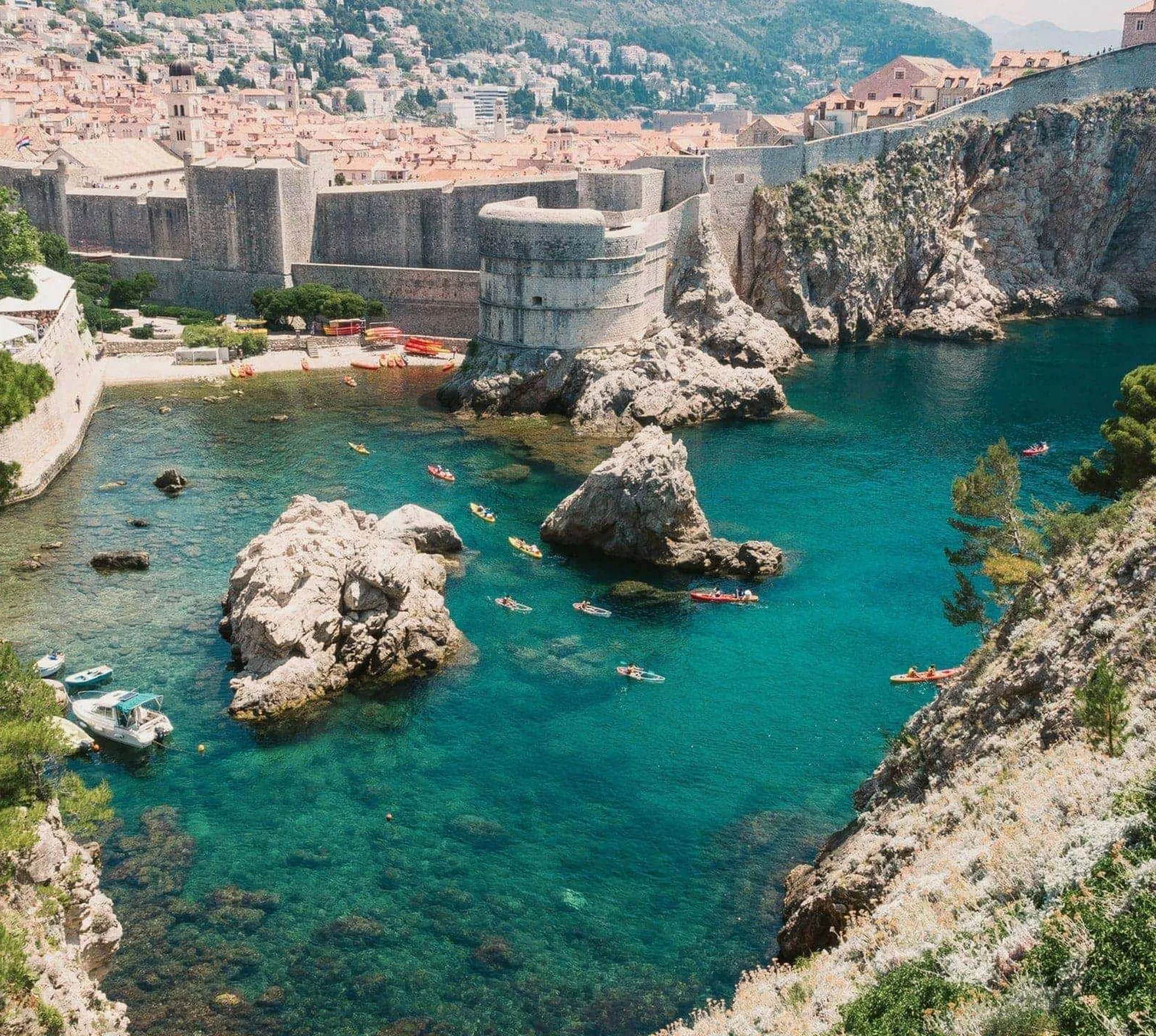 Crystal-clear turquoise waters meet the medieval walls of Dubrovnik on the Contiki Best of Balkans Tour