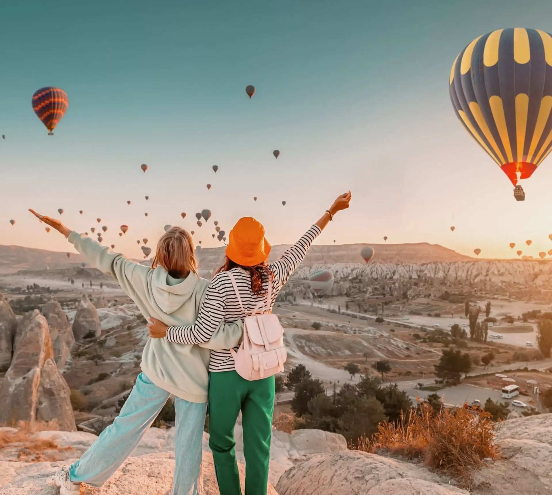 Travellers watch hot air balloons rise over Cappadocia at sunrise on the Contiki Best of Turkey Tour