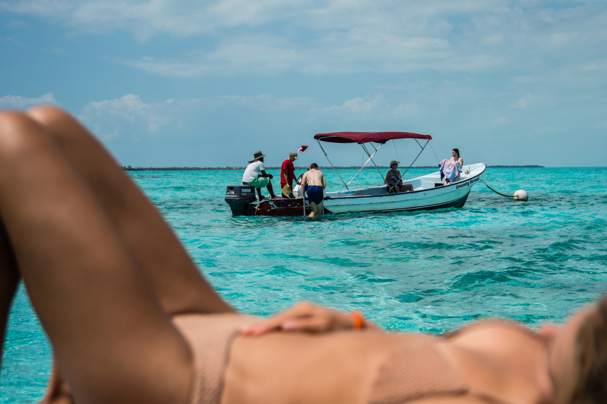 faq-tile-woman-sunbathing-with-view-of-boat-in-caye-caulker-belize.jpg