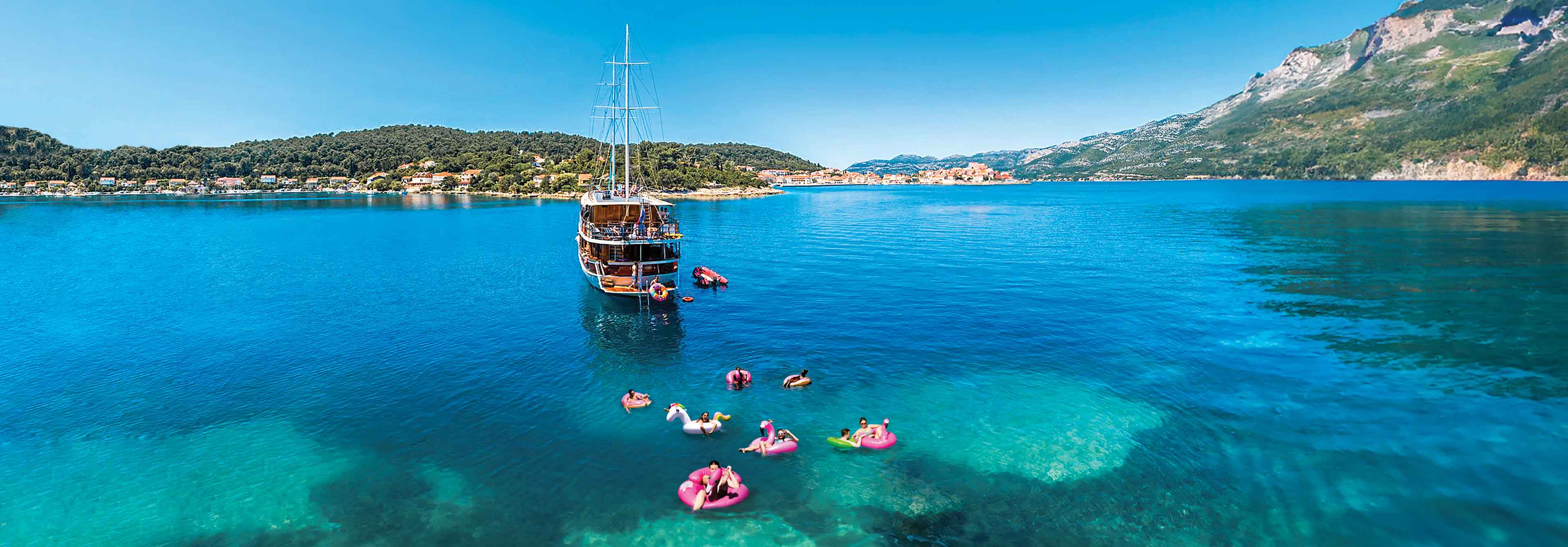 Boat People Swimming In Big Blue Sea 