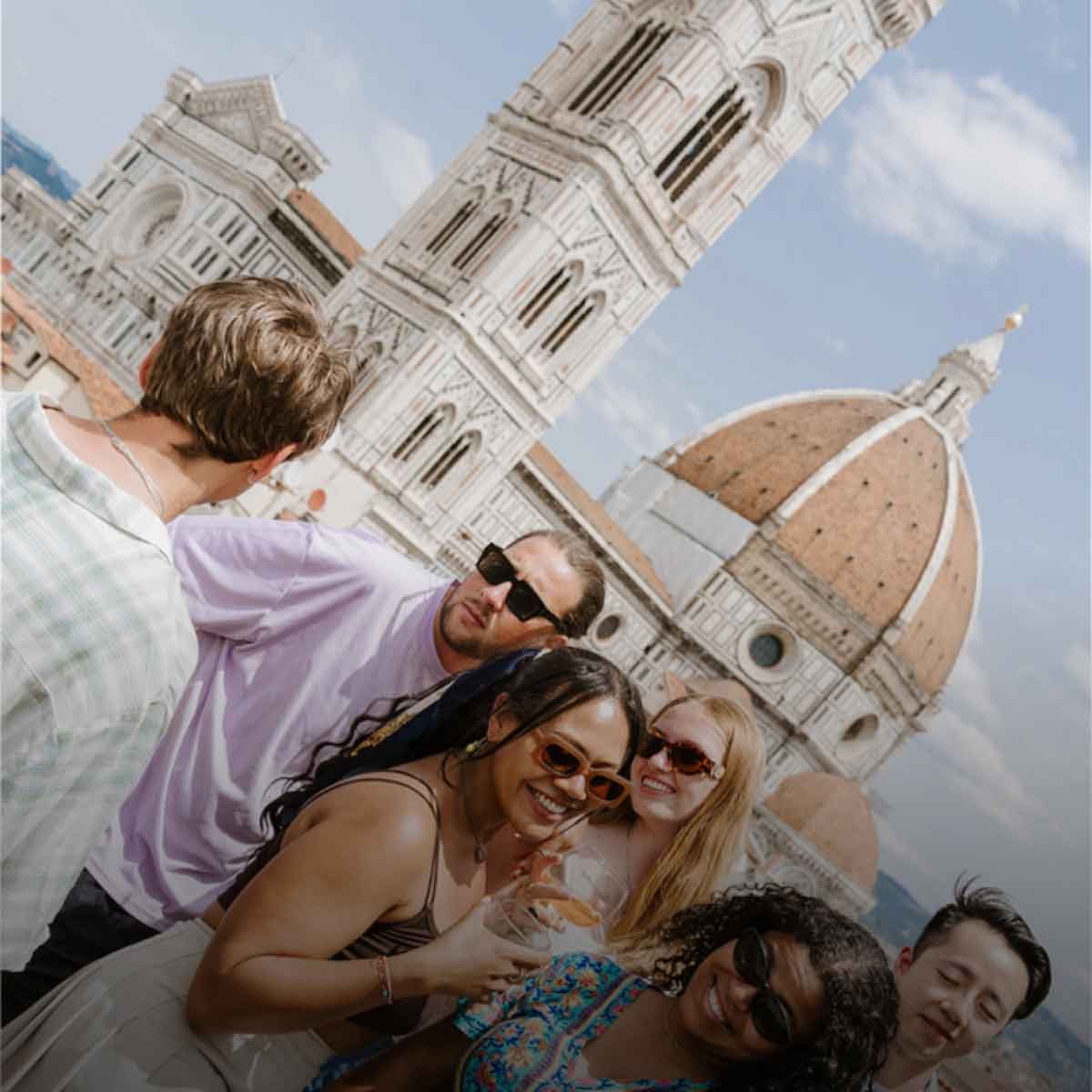 Group Enjoying Aperol Sprit On Balcony In Europe