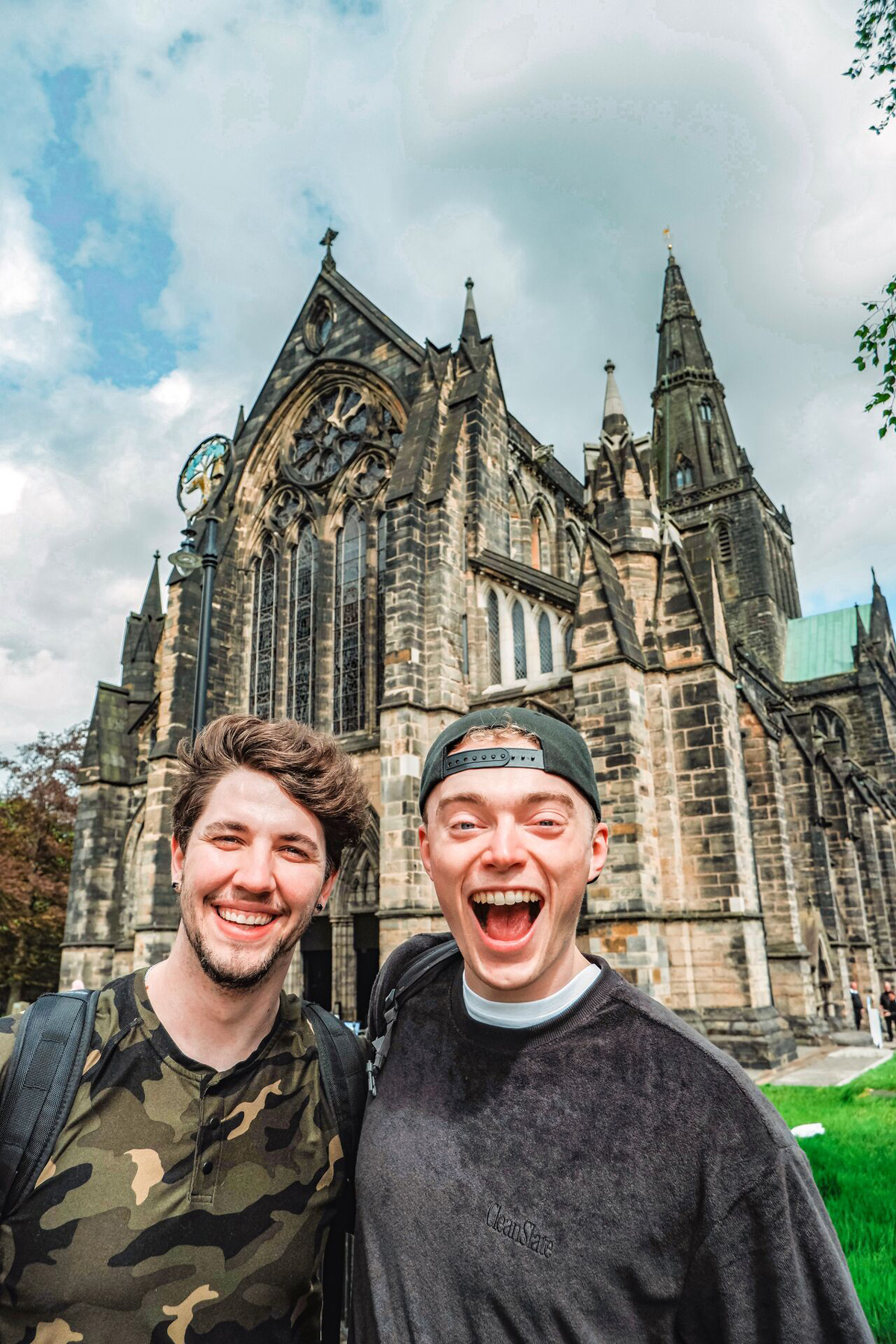 Friends Smiling Landmark Building At The Back in Scotland.
