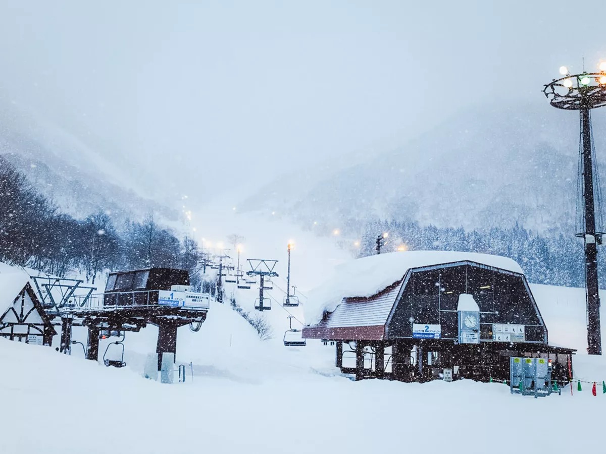 Snowy mountain landscape with a ski lift.