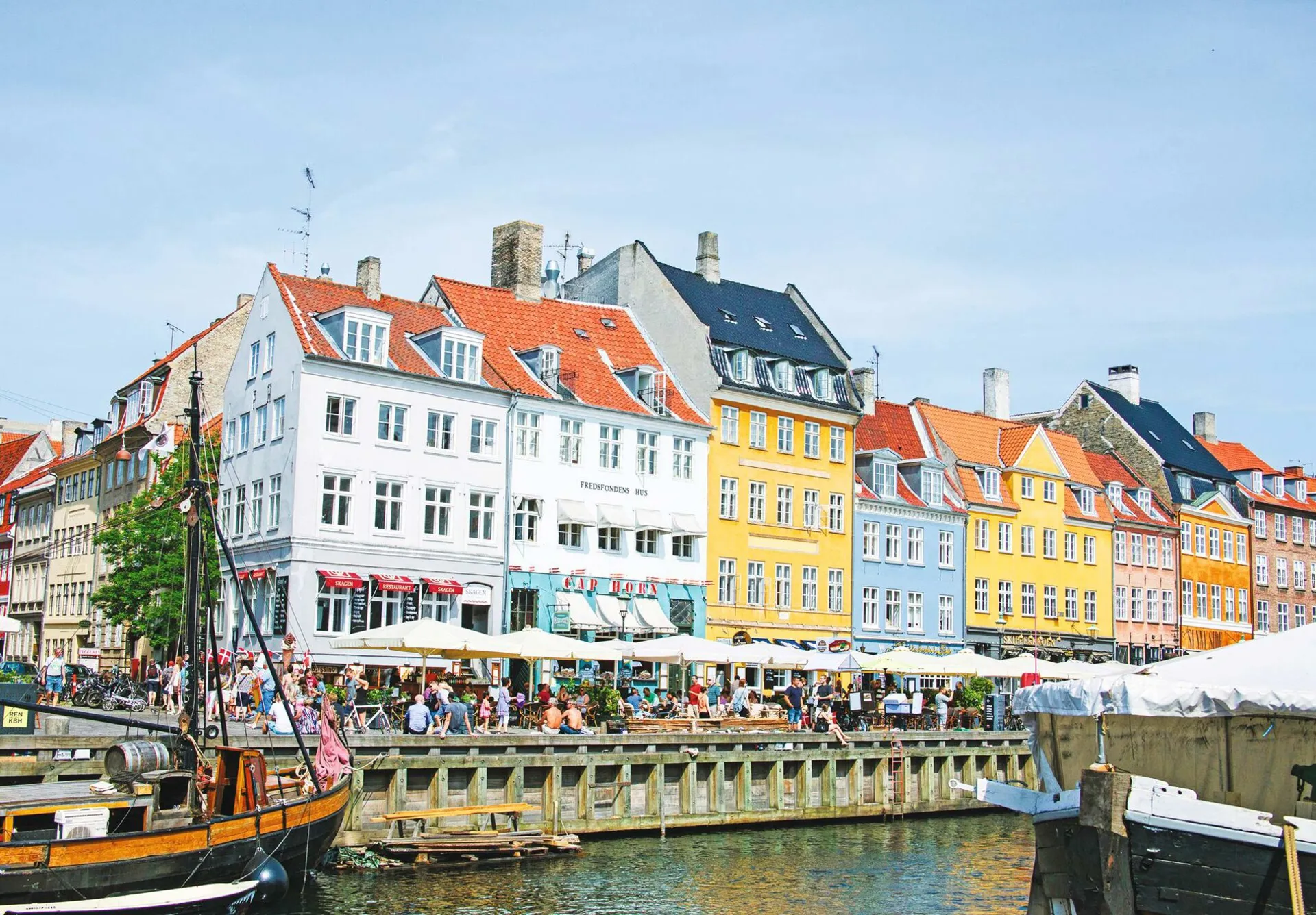 Colourful houses next to a canal on a sunny day in Denmark.