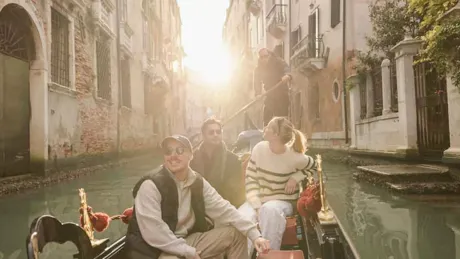 Travellers In Winter In Canals In Venice