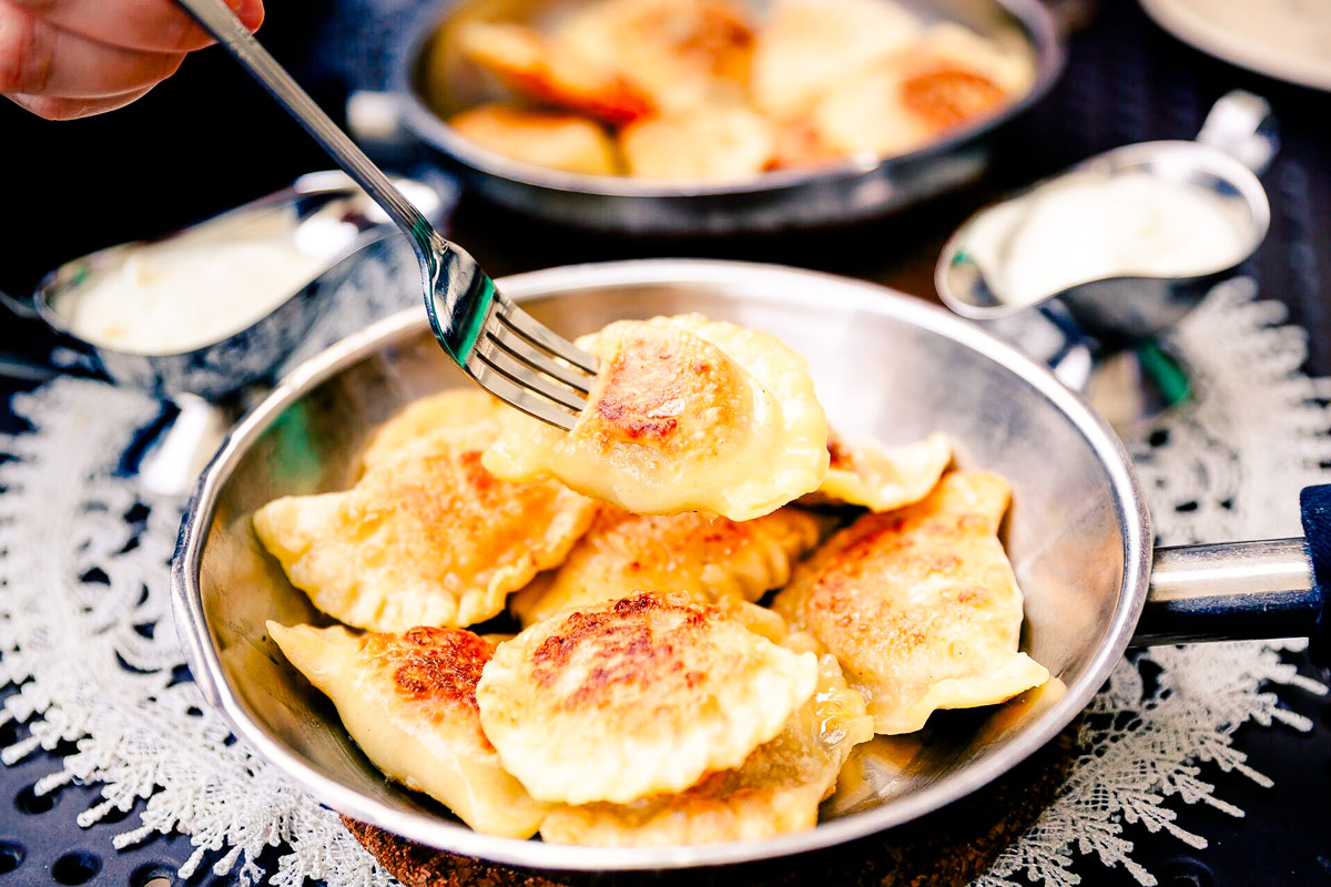 Eating Traditional Polish Dumplings Pierogi With Fork