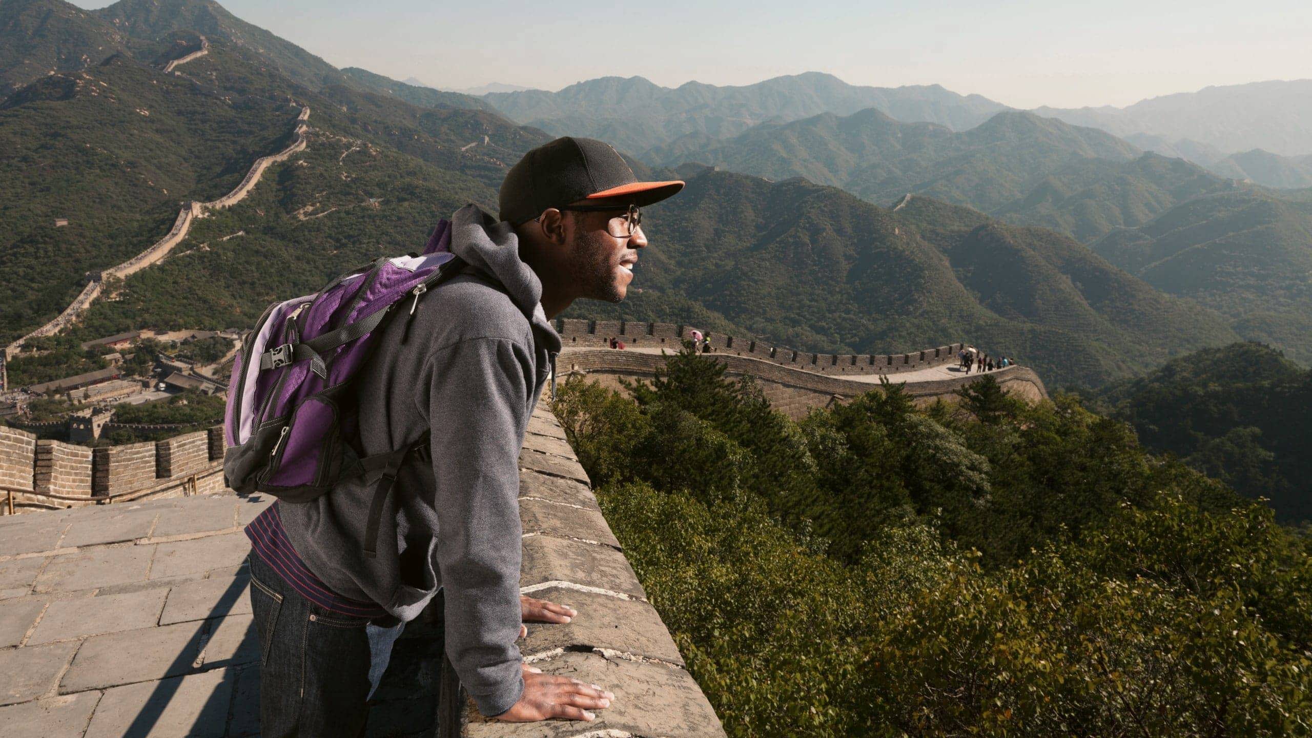 A traveller takes in sweeping views from the Great Wall of China on the Contiki Best of China Tour