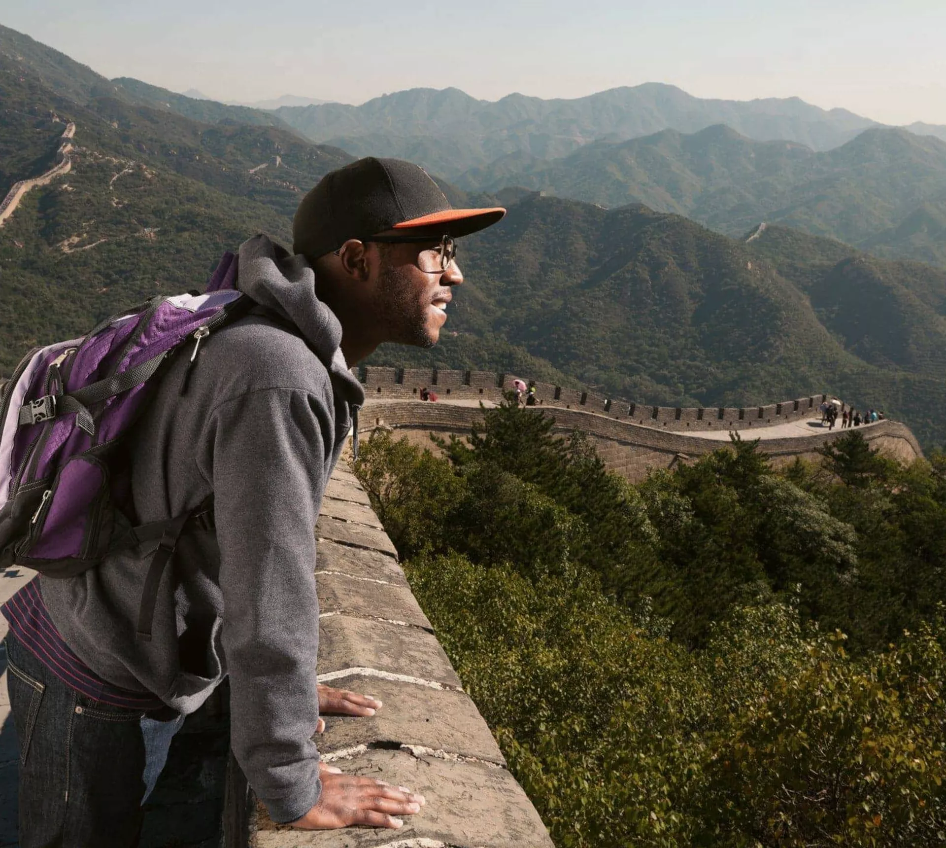 A traveller takes in sweeping views from the Great Wall of China on the Contiki Best of China Tour