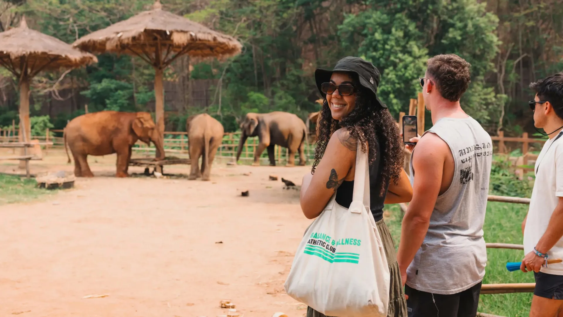 A group watching elephants in a sanctuary - Contiki Thailand, Laos & Cambodia Uncovered Tour