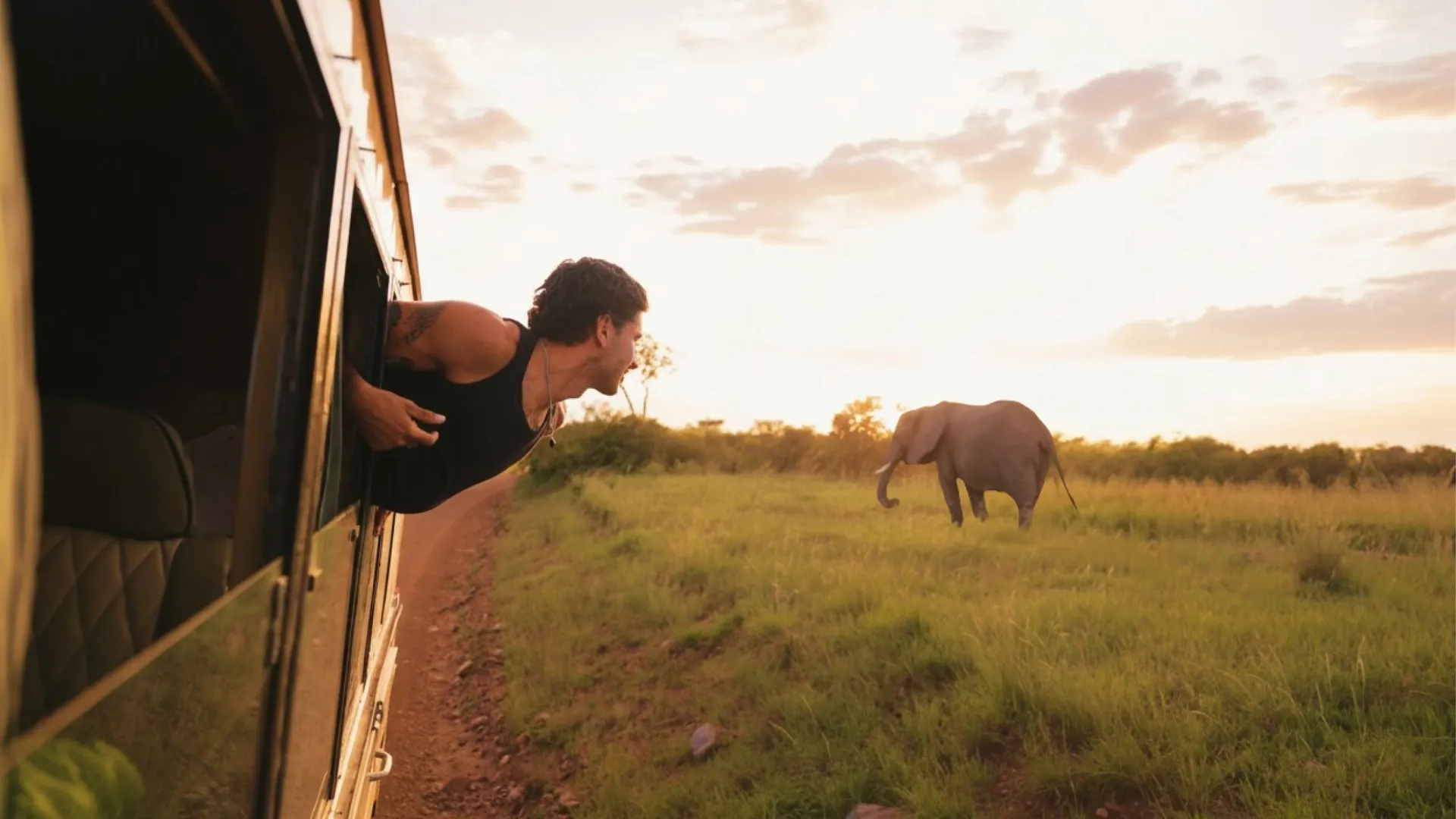 Contiki traveller spotting an elephant on safari - Contiki Best of Uganda & Kenya Tour