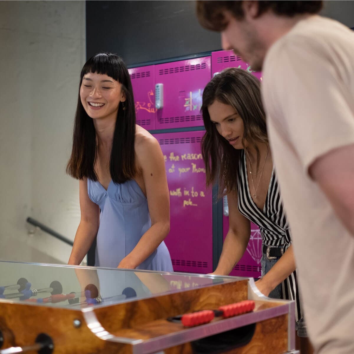 Group of happy visitors playing table football in Moxy Hotel Berlin