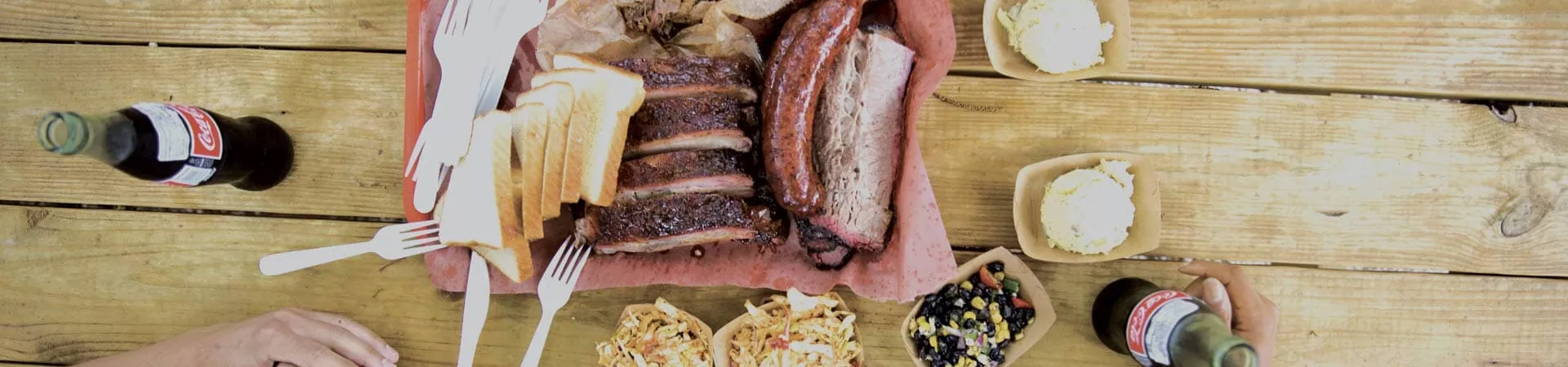 Food and drinks on the table, people's hands
