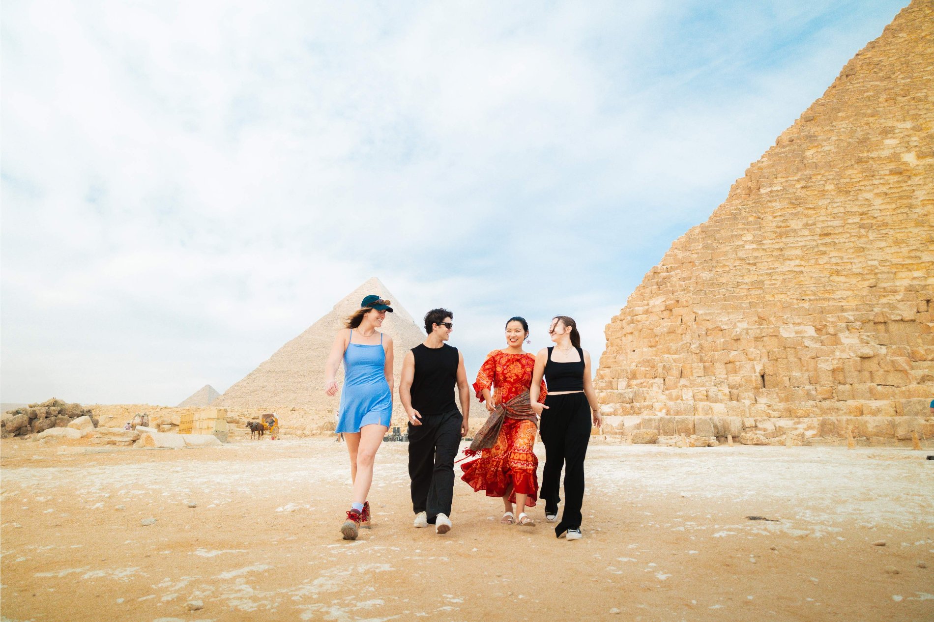 Four friends walking pyramids at the back.