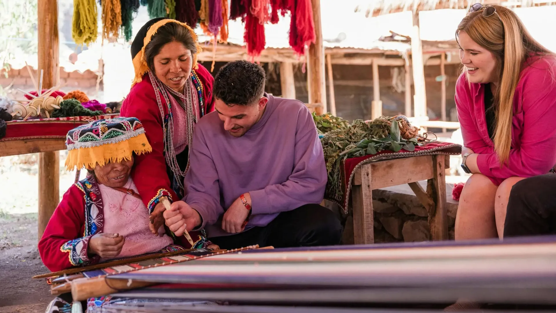 Local artisans demonstrating traditional Andean weaving - Contiki South American Explorer Tour