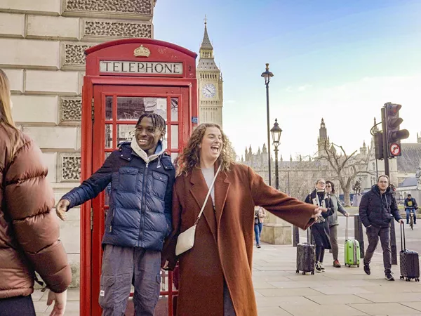 Friends Taking A Picture Close To A Phone Box Big Ben As Background