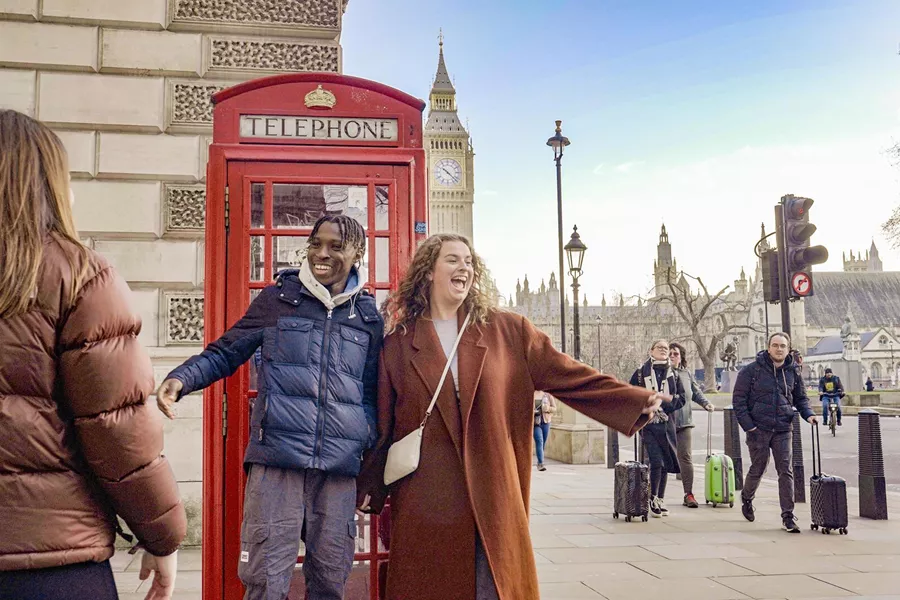 Friends Taking A Picture Close To A Phone Box Big Ben As Background