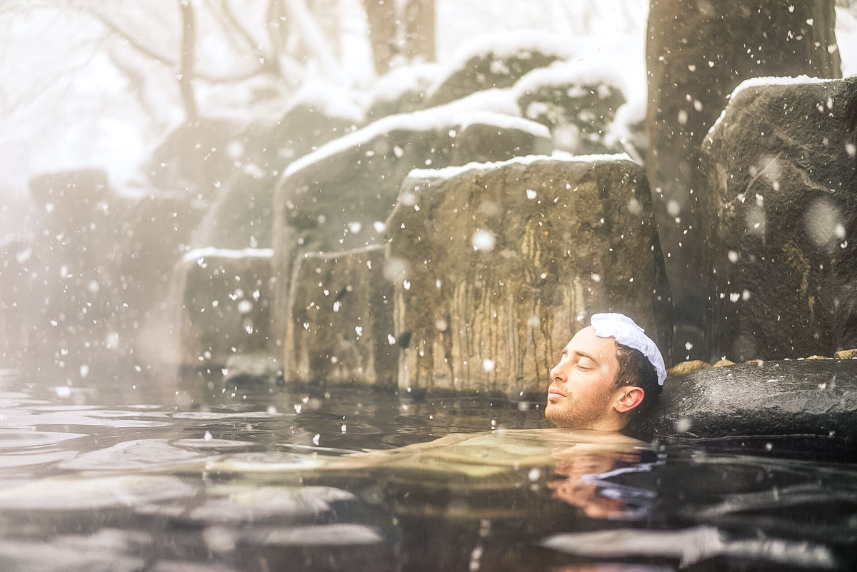 Tourist Enjoying Natural Hot Spring Onsen During Winter Snow