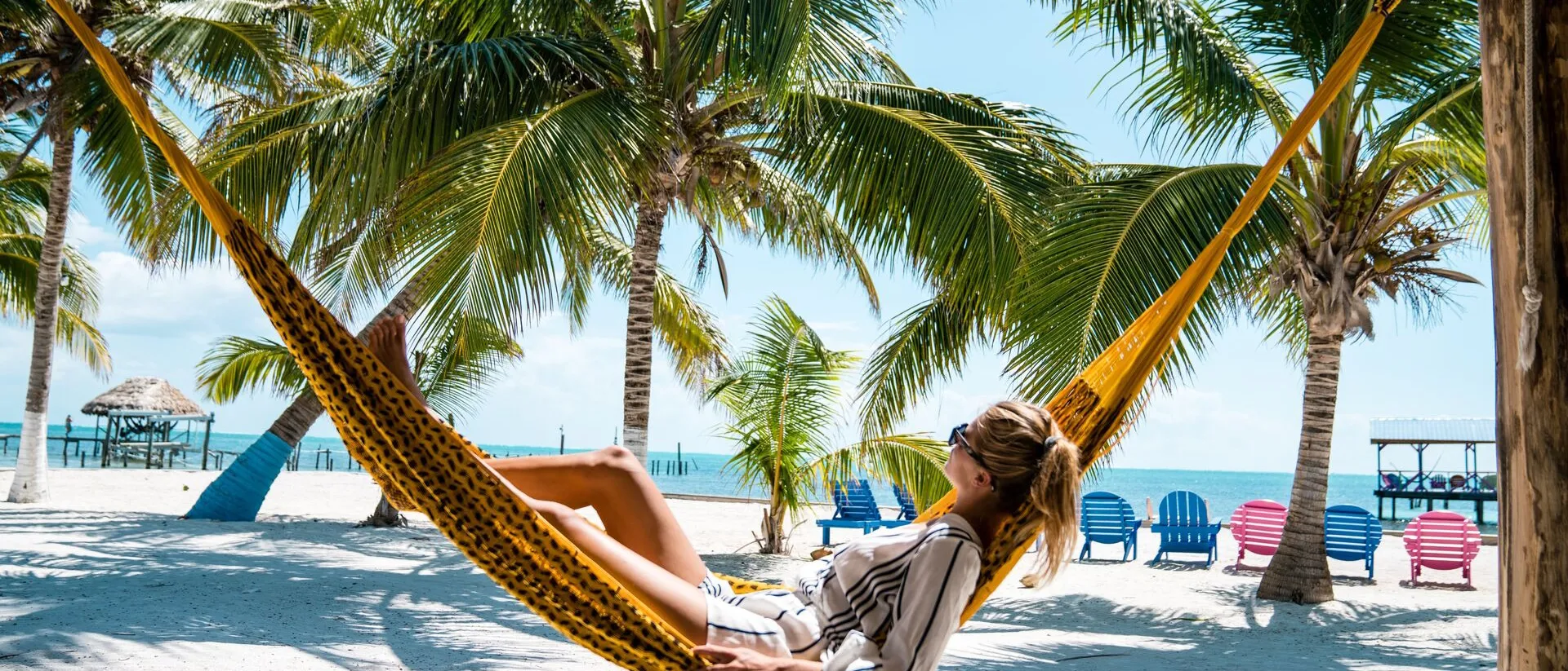 A woman laying in a hammock on the beach, Caribbean