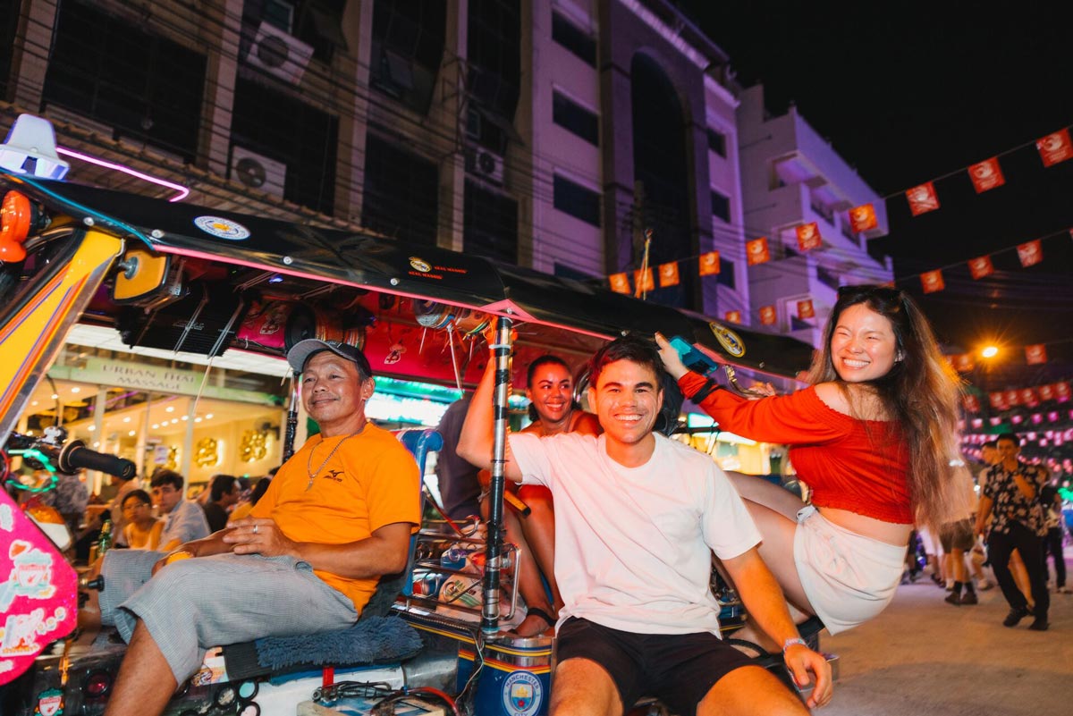 Friends Enjoying A Ride In A Tuktuk At Night