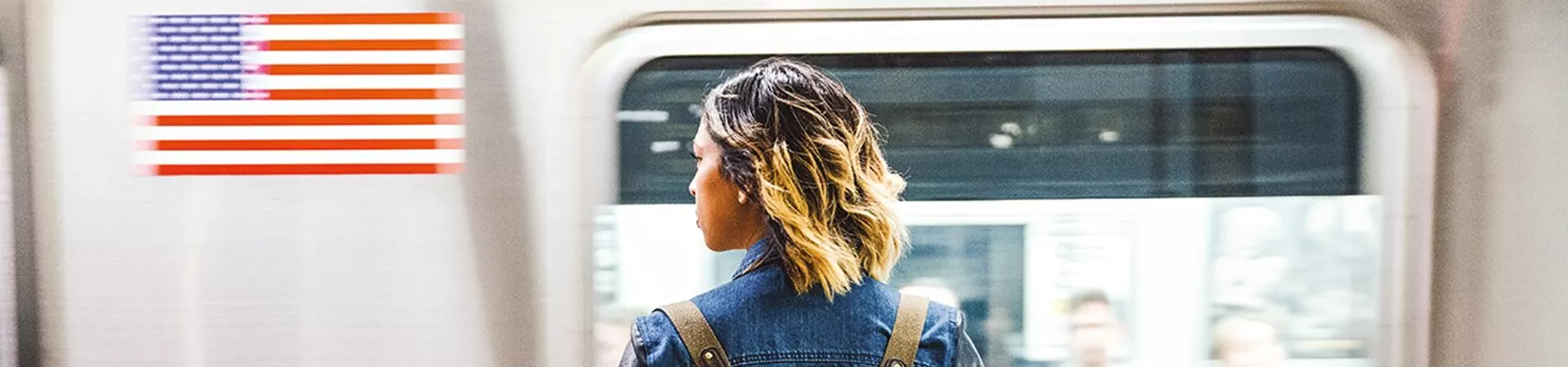 Girl with backpack in front of the train