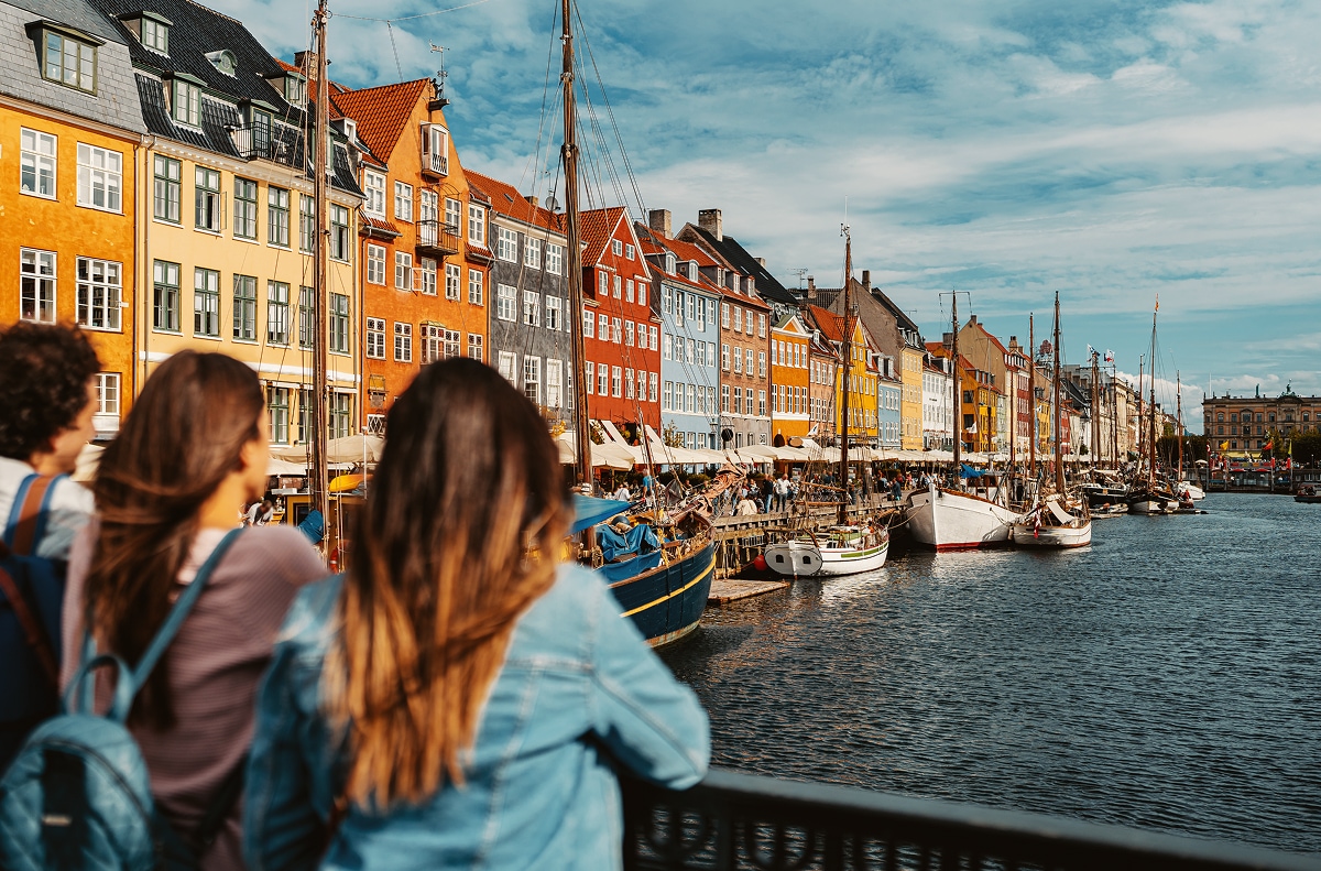 Travellers Looking Over Copenhagen Harbour Boats