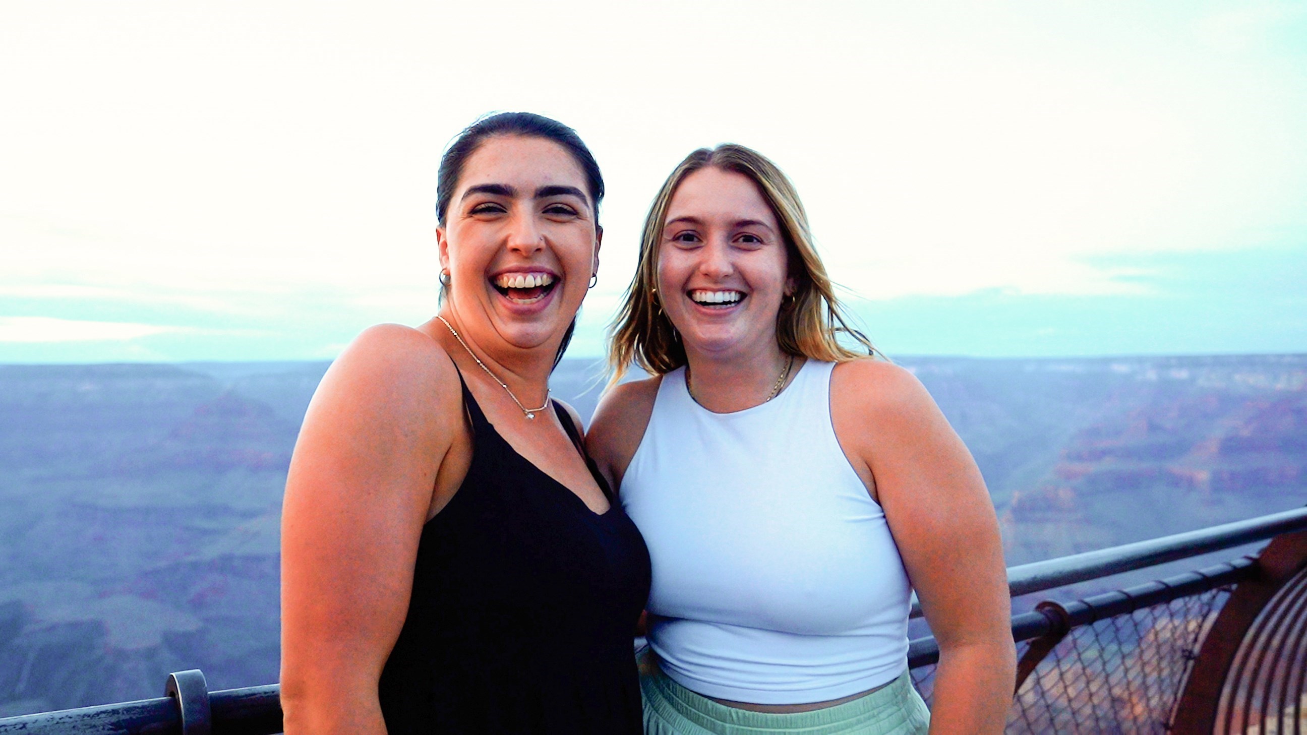 Two Travellers Smiling for Photo at Viewpoint of the Grand Canyon, USA