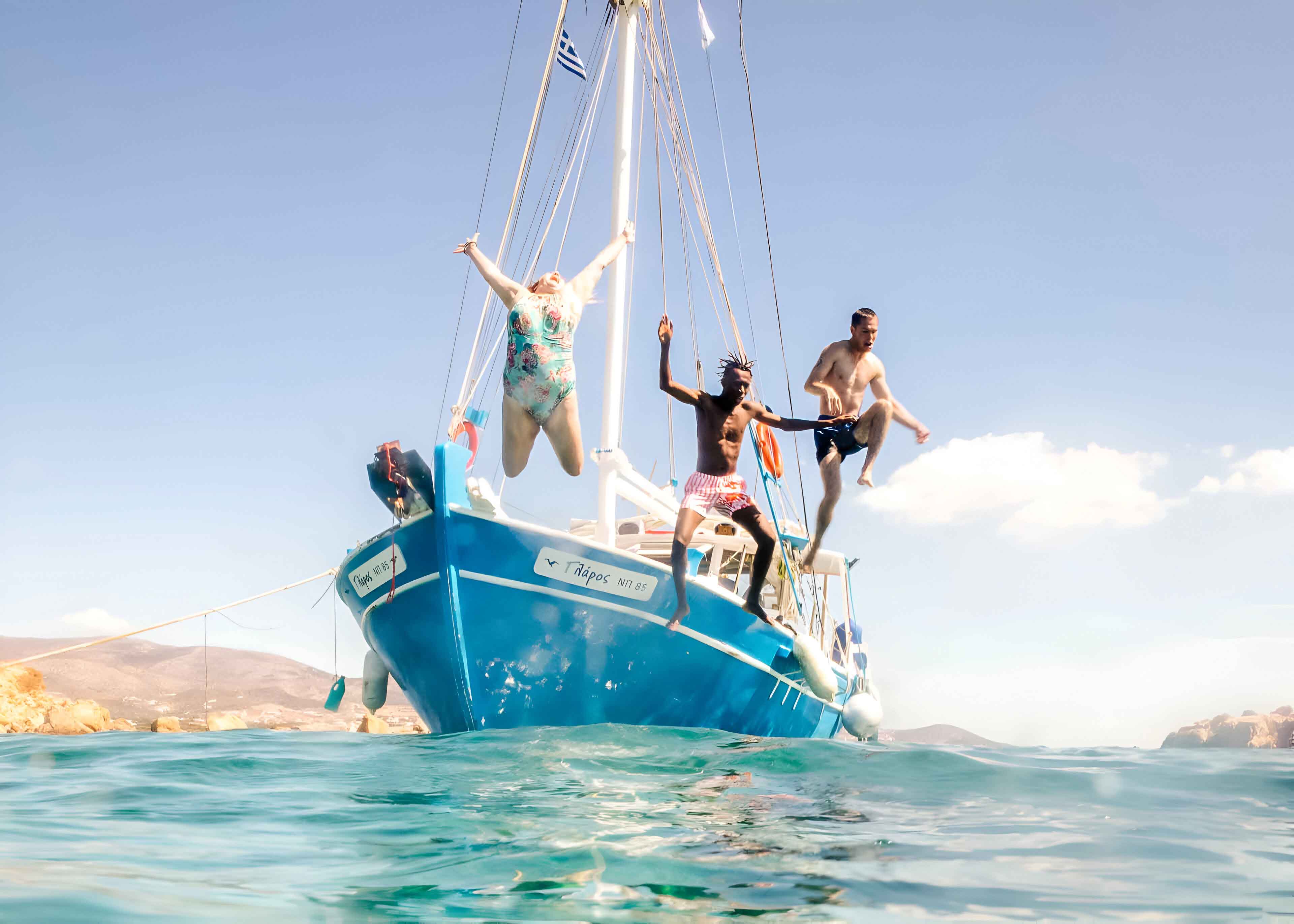 Group Jumping Into Sea From Boat In Greece