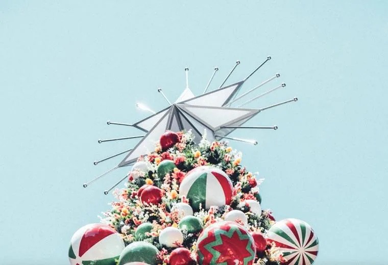 Top of a Christmas tree with colourful bulbs and a star
