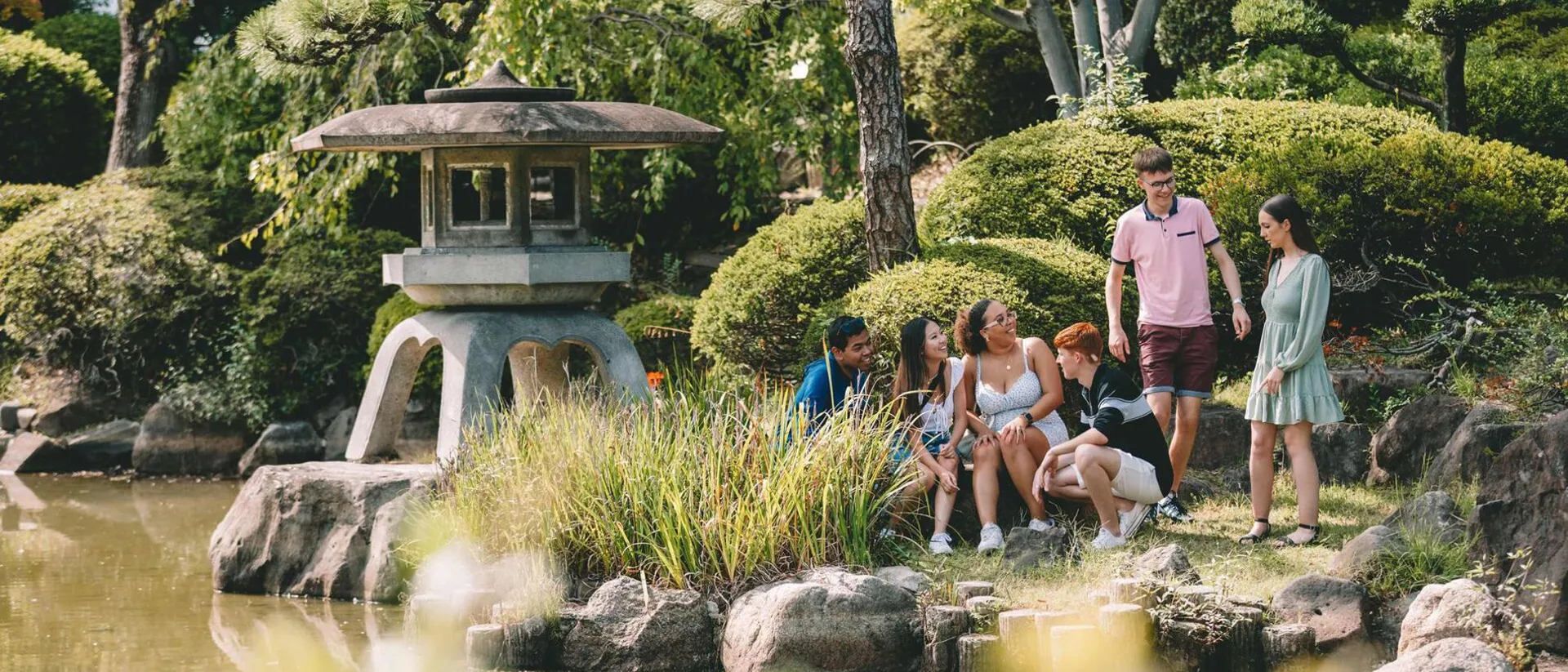 Japan Osaka Group Of Young People Enjoying A Moment In A Beautiful Garden
