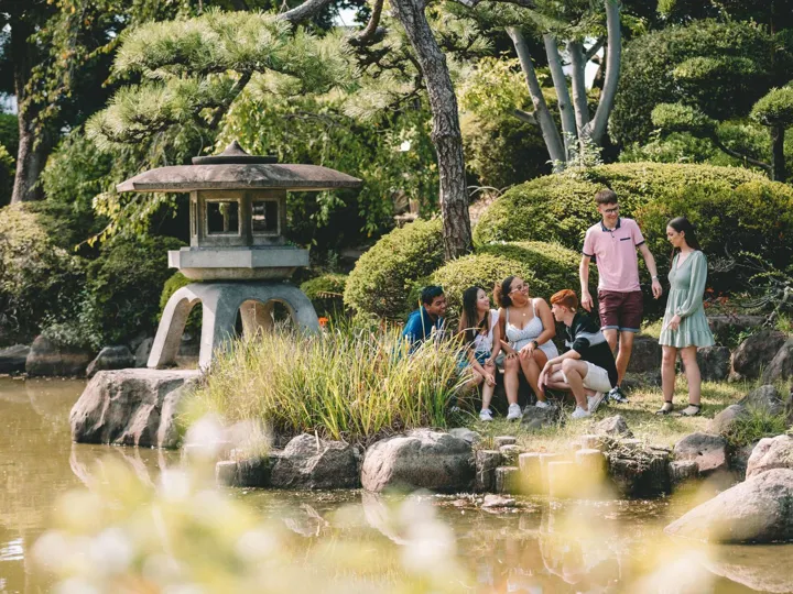 Japan Osaka Group Of Young People Enjoying A Moment In A Beautiful Garden