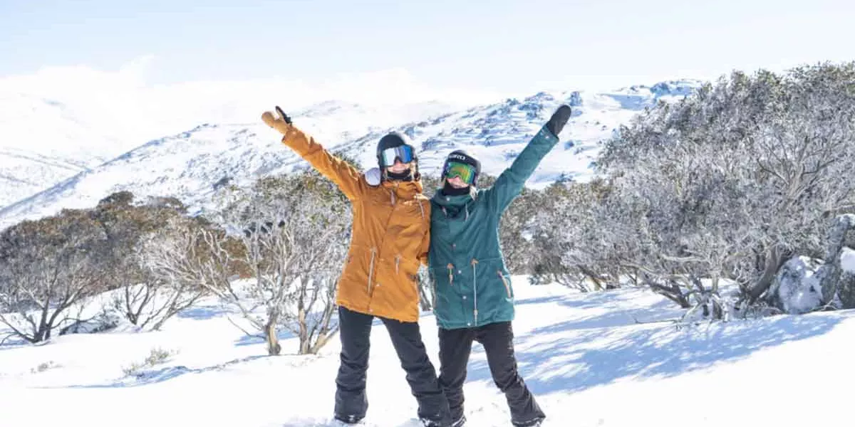 Two Snowboarders In Snow Posinging For Shot