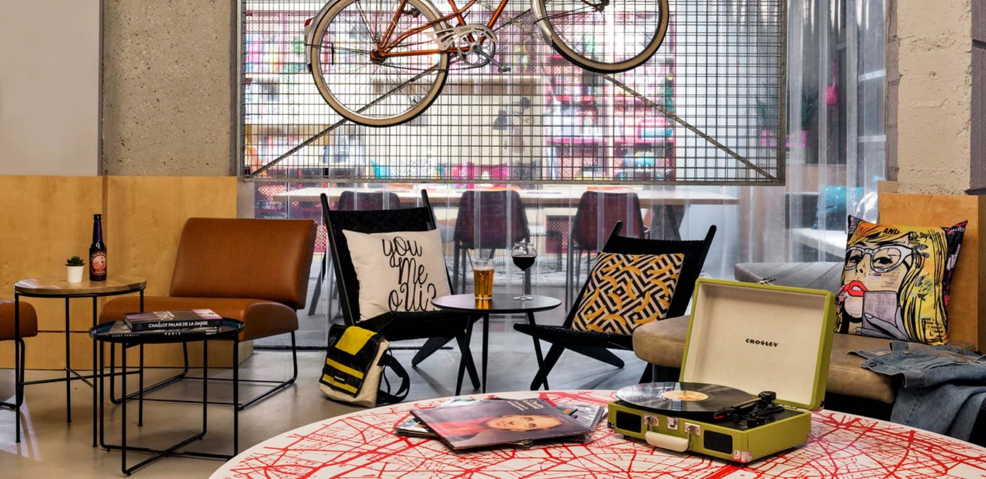 Moxy Paris Bastille chill room with armchairs, vinyls and bicycle hanging on the wall