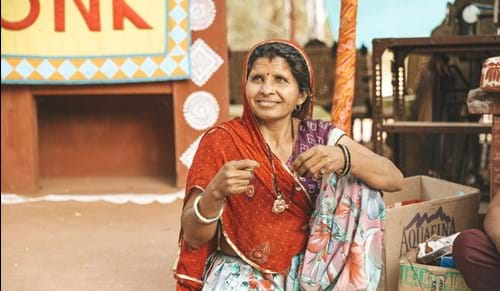 Indian woman holding jewelry