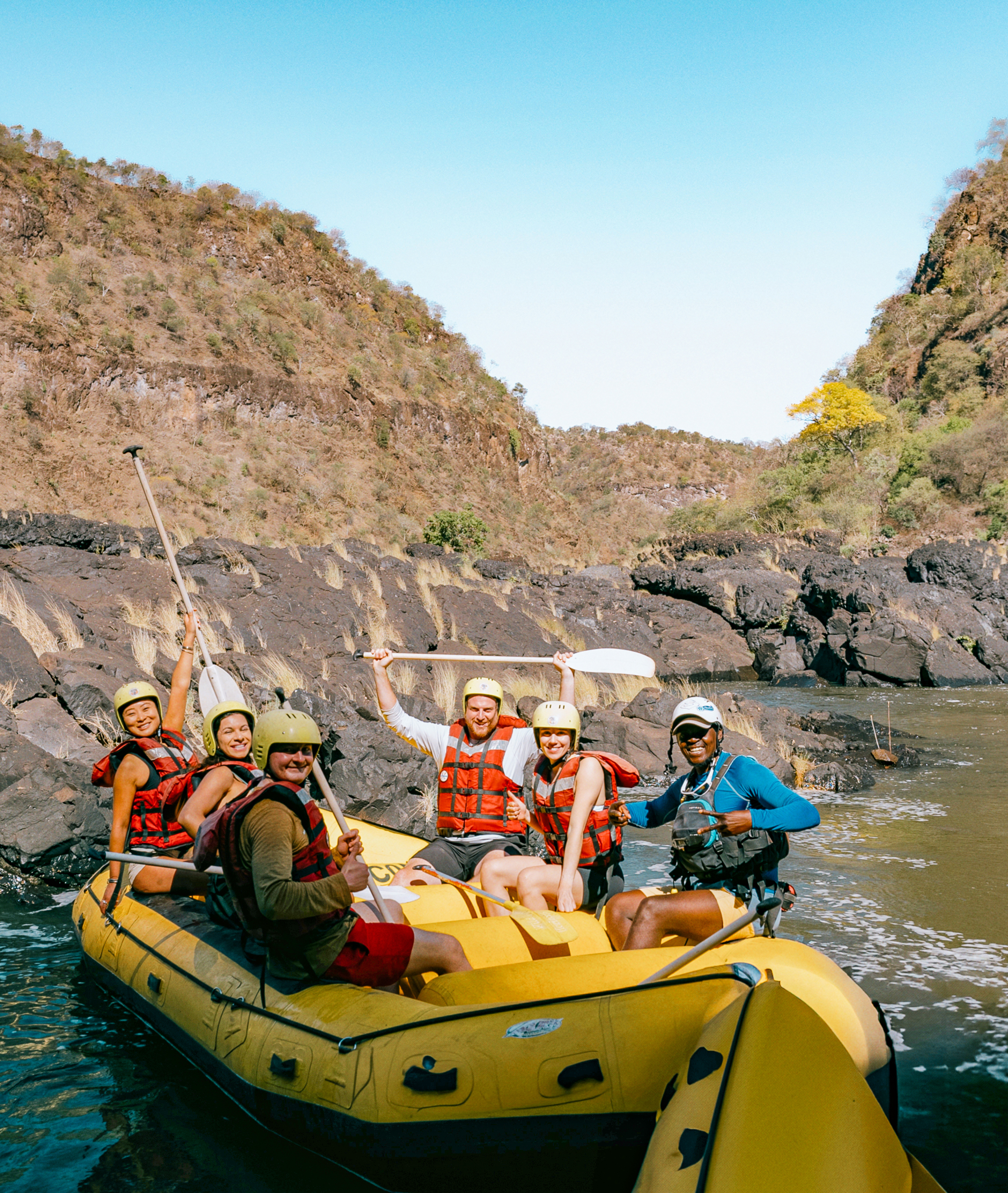 Travellers rafting on the Zambezi River at Victoria Falls in Zambia