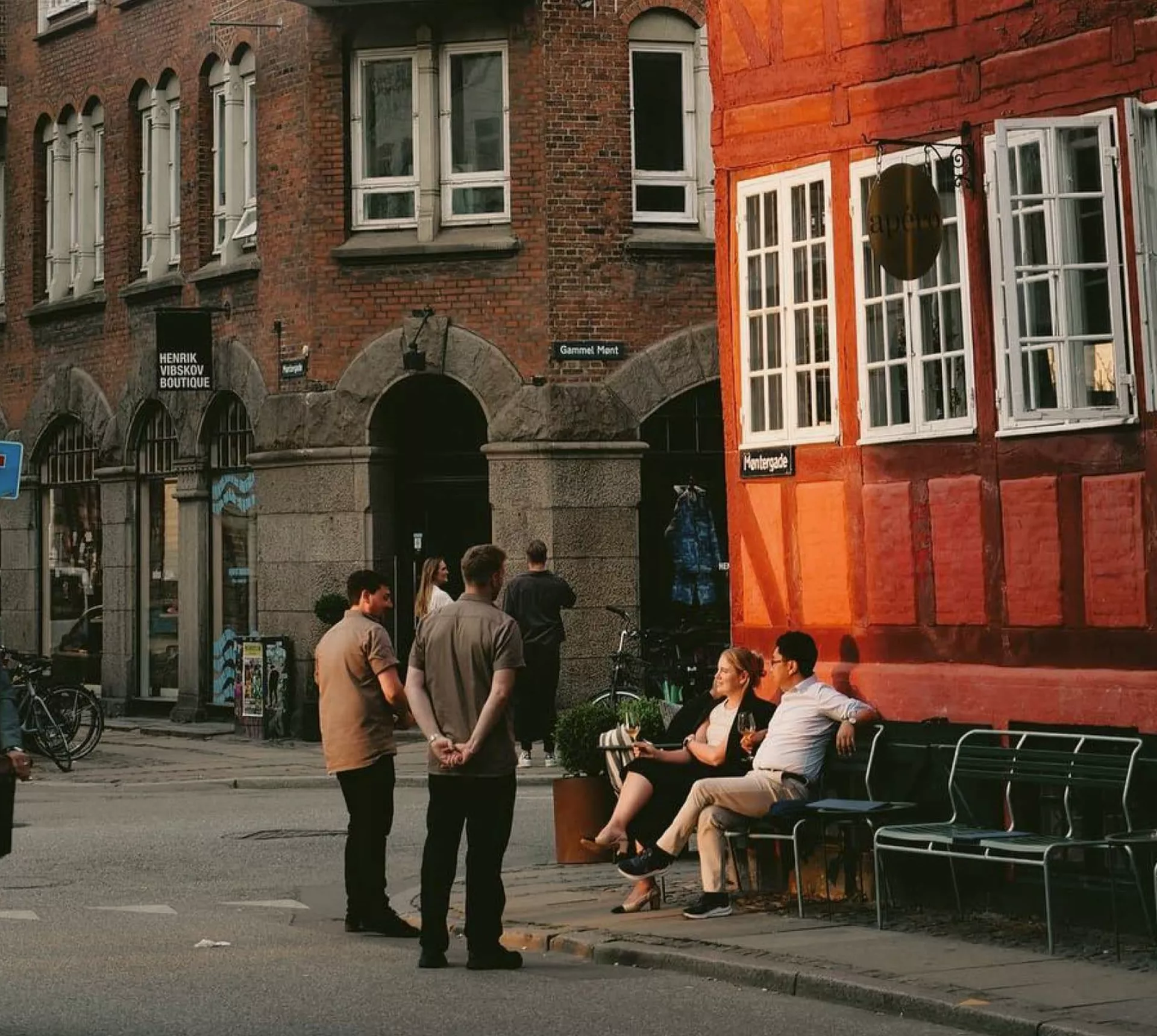 People enjoying a café on a historic street in Copenhagen, Denmark - Contiki Best of Scandinavia & The Baltics Tour
