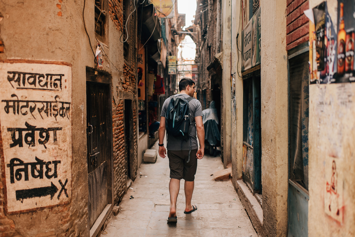 Man Walking In A Narrow Road Red Brick Buildings