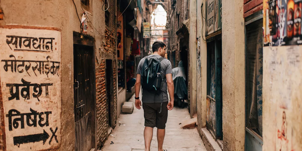 Man Walking In A Narrow Road Red Brick Buildings