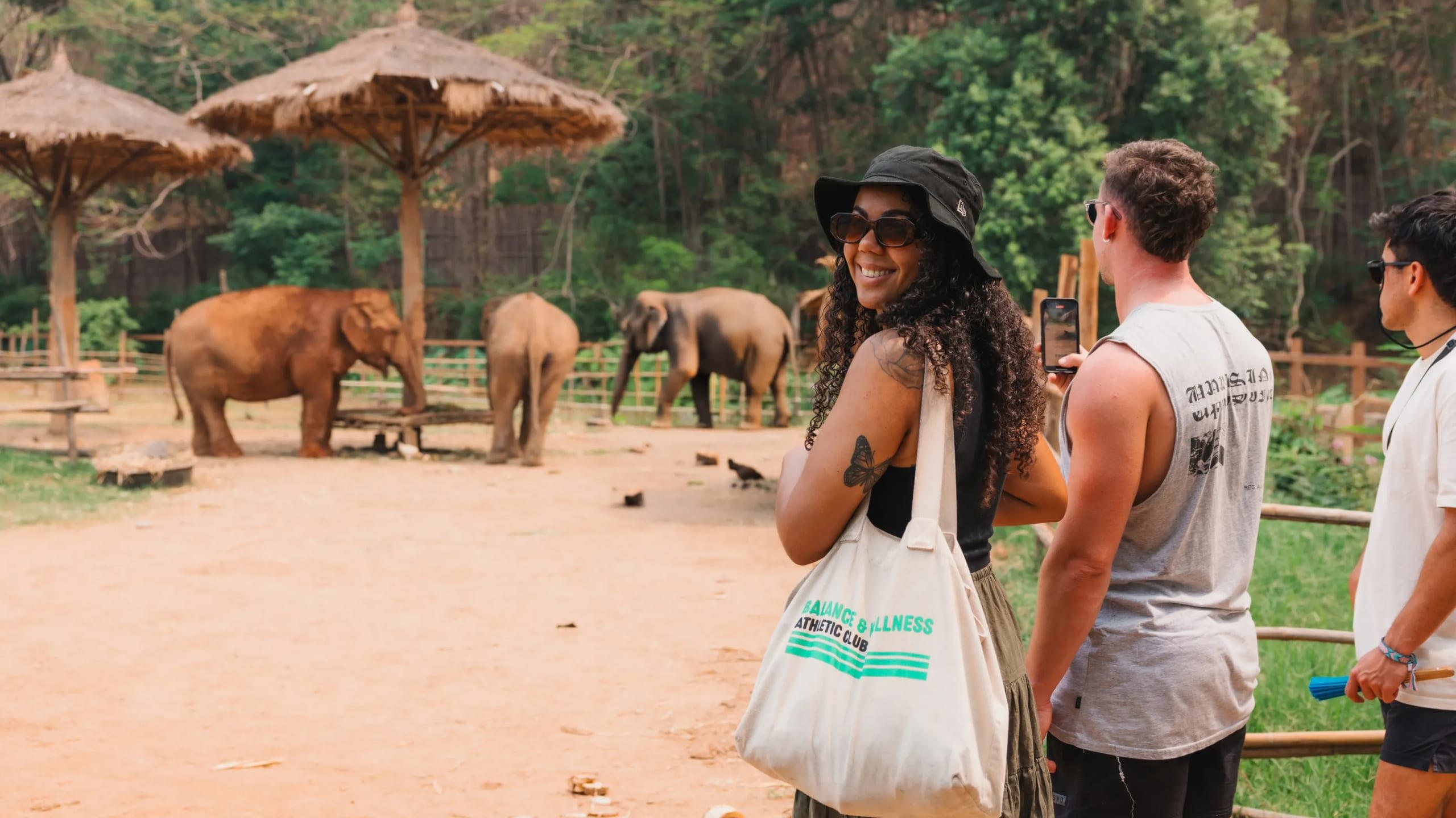 A group watching elephants in a sanctuary - Contiki Thailand, Laos & Cambodia Uncovered Tour