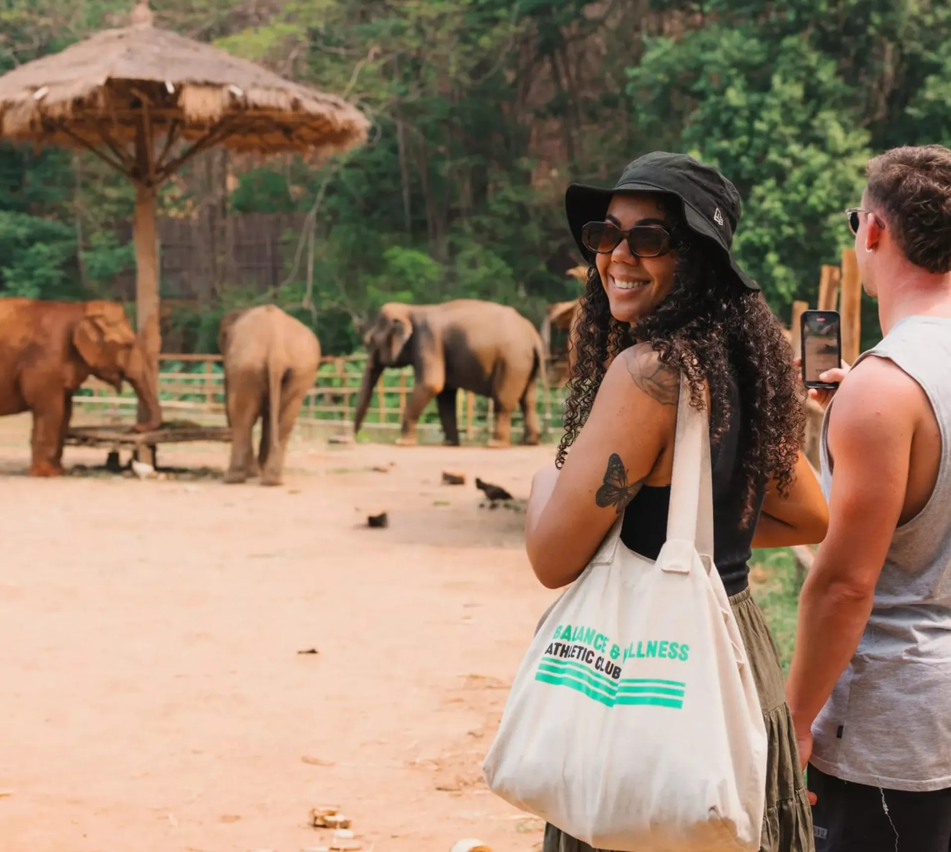 A group watching elephants in a sanctuary - Contiki Thailand, Laos & Cambodia Uncovered Tour