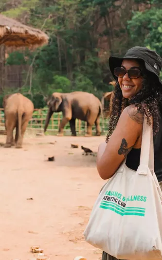 A group watching elephants in a sanctuary - Contiki Thailand, Laos & Cambodia Uncovered Tour