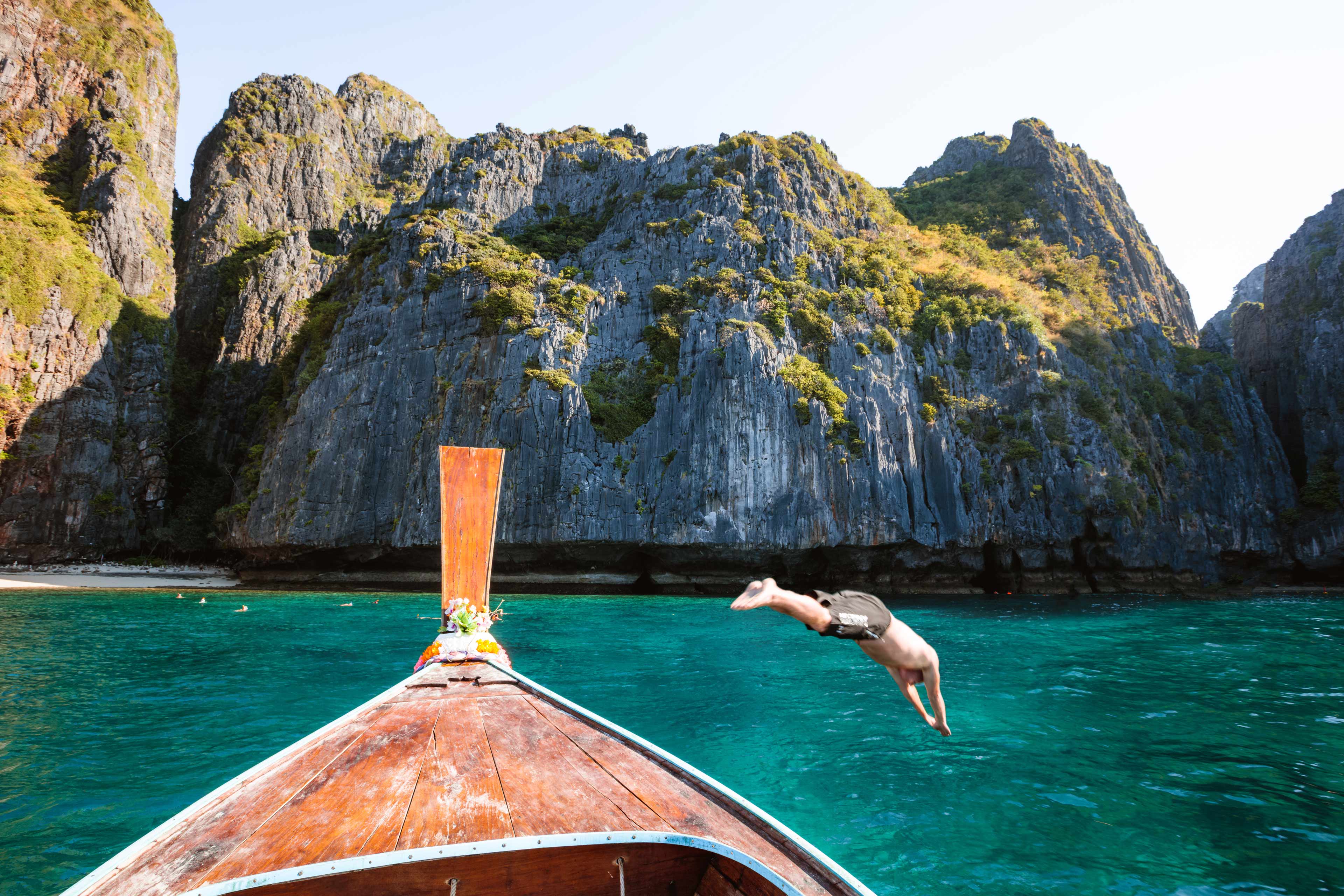 Man Diving From Boat Prow Phi Phi Island