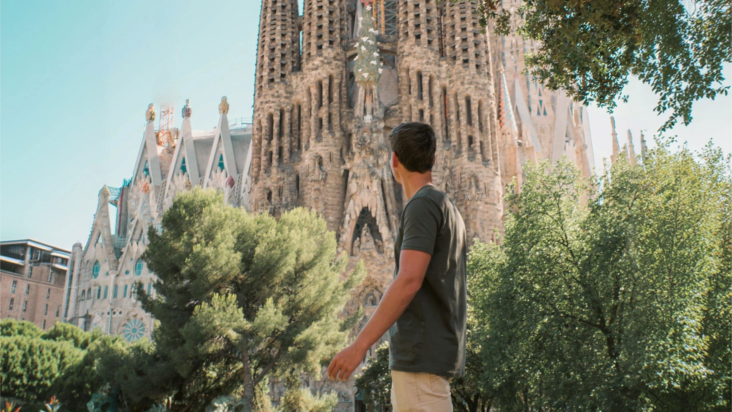Barcelona's spectacular Sagrada Família towers above a traveller exploring the city on the Contiki Best of Spain Tour