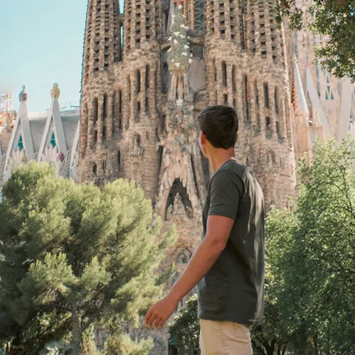 Barcelona's spectacular Sagrada Família towers above a traveller exploring the city on the Contiki Best of Spain Tour