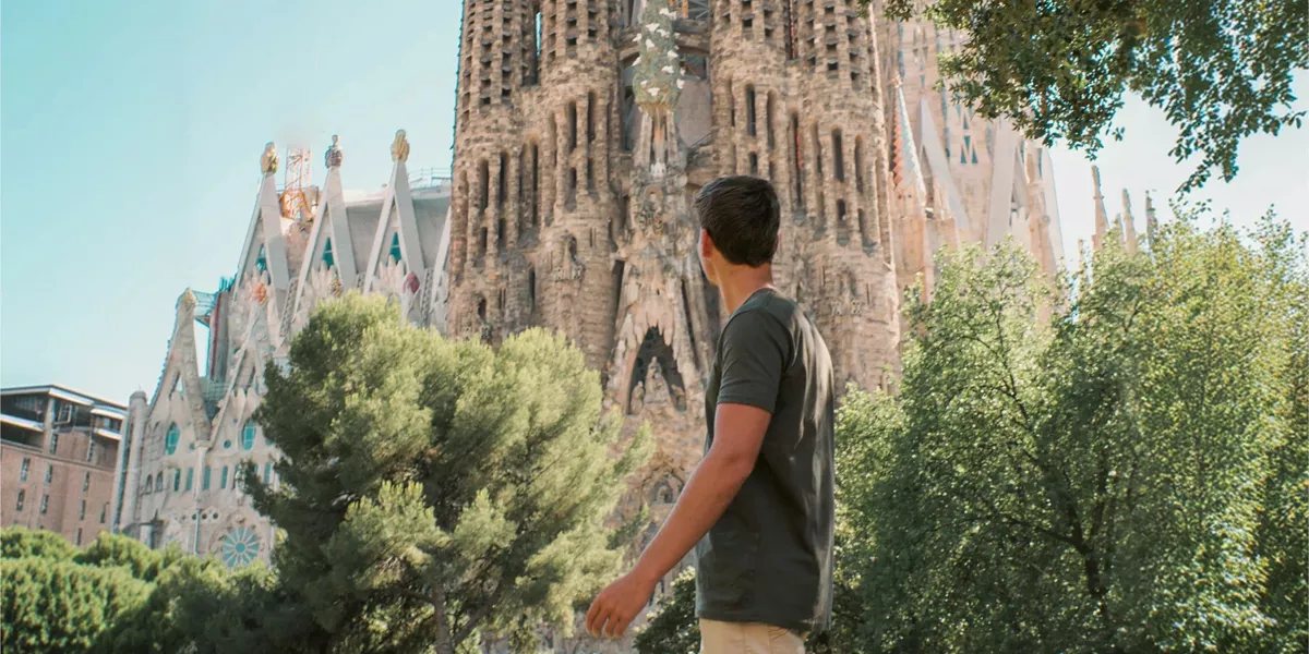 Barcelona's spectacular Sagrada Família towers above a traveller exploring the city on the Contiki Best of Spain Tour