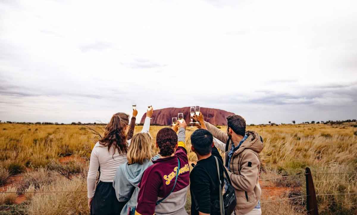 Group Raising Their Glass To Ayers Rock Australia
