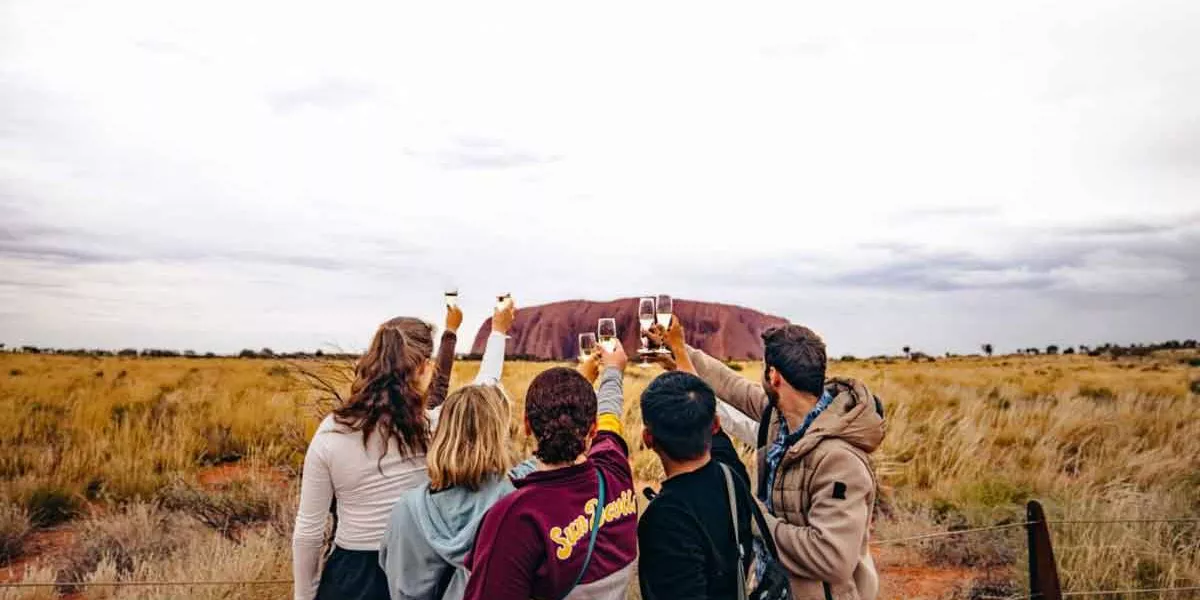Group Raising Their Glass To Ayers Rock Australia