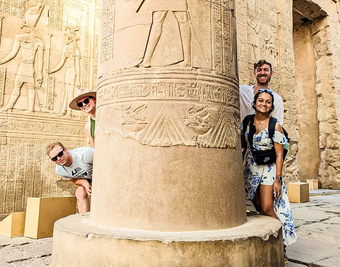 Travellers next to ancient Egyptian architecture, Egypt