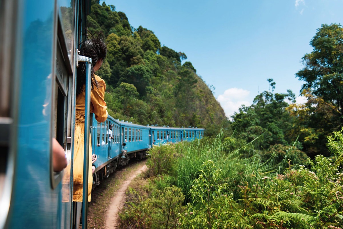 Woman taking the train ride in Sri Lanka's tea plantations.