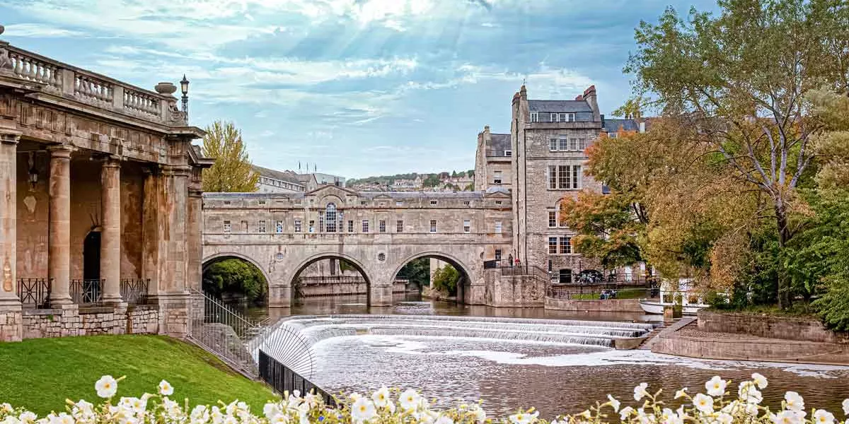 Classic Village In England With Bridge And River