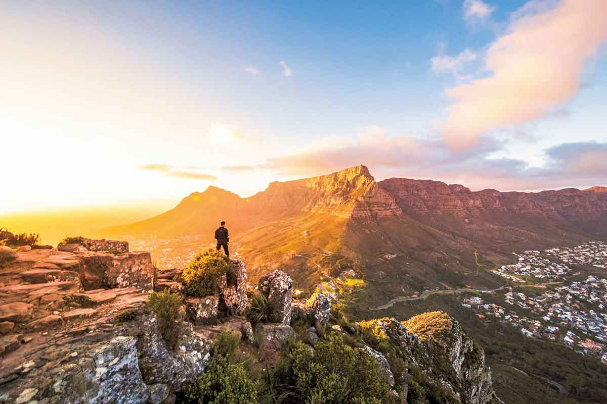 Man At The Top Of Mountains In Cape Town Looking At Mountains